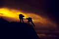 Silhouette of helping hand between two climber Royalty Free Stock Photo