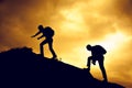 Silhouette of helping hand between two climber Royalty Free Stock Photo