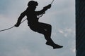 Adventure Silhouette man High angle view of rappelling Royalty Free Stock Photo