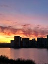 Silhouette of high-rise residential buildings at sunset near the lake Royalty Free Stock Photo