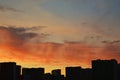 Silhouette of high-rise residential buildings at sunset near the lake Royalty Free Stock Photo