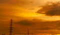 Silhouette high voltage electric pylon and electrical wire with an orange sky. Electricity poles at sunset. Power and energy Royalty Free Stock Photo