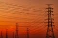 Silhouette high voltage electric pylon and electrical wire with an orange sky. Electricity poles at sunset. Power and energy Royalty Free Stock Photo