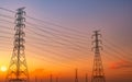 Silhouette high voltage electric pylon and electrical wire with purple and red sunset sky. Electricity poles at sunset. Power and Royalty Free Stock Photo