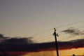 Silhouette high voltage electric tower in dark sunset sky Royalty Free Stock Photo