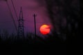 Silhouette high-voltage electric towers during beautiful fiery sunset, stunning sunset background