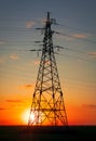 Silhouette High voltage electric towers at sunset time. High-voltage power lines. Electricity distribution station Royalty Free Stock Photo