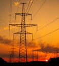 Silhouette High voltage electric towers at sunset time. High-voltage power lines. Electricity distribution station Royalty Free Stock Photo