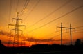 Silhouette High voltage electric towers at sunset time. High-voltage power lines. Electricity distribution station Royalty Free Stock Photo