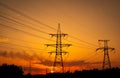 Silhouette High voltage electric towers at sunset time. High-voltage power lines. Electricity distribution station Royalty Free Stock Photo