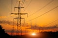 Silhouette High voltage electric towers at sunset time. High-voltage power lines. Electricity distribution station Royalty Free Stock Photo