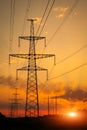 Silhouette High voltage electric towers at sunset time. High-voltage power lines. Electricity distribution station Royalty Free Stock Photo