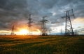 Silhouette High voltage electric towers at sunset time. High-voltage power lines. Electricity distribution station Royalty Free Stock Photo