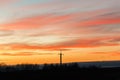 Silhouette of high voltage power lines against the background of dramatic sky at sunset Royalty Free Stock Photo