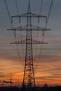 Silhouette of high voltage power lines against a sunset sky Royalty Free Stock Photo