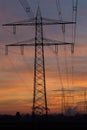 High voltage power lines and pylons after sunset. Royalty Free Stock Photo