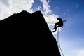 Silhouette of a hiker in an extremely dangerous pose trying to find new adventures