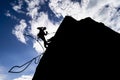 Silhouette of a hiker in an extremely dangerous pose trying to find new adventures