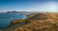 Silhouette of hiker on a hill in a Crimea mountain valley