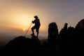 Silhouette of hiker standing on top mountain sunset background. Hiker men\'s hiking living healthy active lifestyle Royalty Free Stock Photo