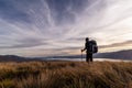 Silhouette of a hiker in sunset, Lake Tekapo, New Zealand