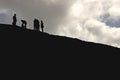 Silhouette of hikers on cliff, rock-climbing Royalty Free Stock Photo