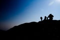 Silhouette of hikers walking up a mountain side Royalty Free Stock Photo