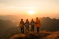 Silhouette of the hiking male and female hikers climbing up mountain, in winner pose, teamwork concept Royalty Free Stock Photo