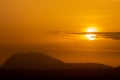 Silhouette of hills against beautiful golden hour sunset amidst Royalty Free Stock Photo