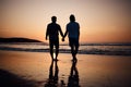 Silhouette, holding hands and gay men on beach, sunset and shadow on summer vacation together in Thailand. Sunshine Royalty Free Stock Photo