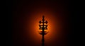 Silhouette of Holy Cross. malankara syrian orthodox with lit brass diya oil stand