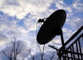 Silhouette of home satellite dish antenna on the balcony with cl Royalty Free Stock Photo