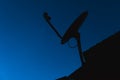 Silhouette Home satellite dish Digital TV antennas on blue Royalty Free Stock Photo