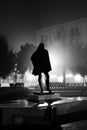 Silhouette of hooded statue at foggy night on Umberto Giordano square in Foggia