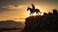 Silhouette of a horse rider on a cliff at sunset Royalty Free Stock Photo