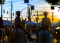 Silhouette of Horse riders at sunset. Seville`s April Fair. Spanish Culture. Royalty Free Stock Photo
