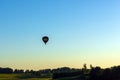 Silhouette hot air balloon in blue sky landscape background.Hot air balloon over the green field Royalty Free Stock Photo