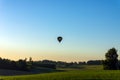 Silhouette hot air balloon in blue sky landscape background.Hot air balloon over the green field Royalty Free Stock Photo