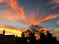 Silhouette of House and Tree Against Sunset