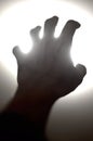 Silhouette of human hand reaching out to light, Need help Royalty Free Stock Photo