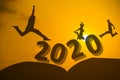 Silhouette of human jump over 2020 years