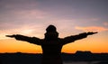 Silhouette of human person hands open palm up worship in sky sunset or sunset. Catholic adult man pray and hope on mountain. Royalty Free Stock Photo