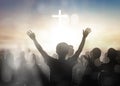 Silhouette human raising hands to praying God on blurred cross background Royalty Free Stock Photo