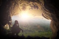 Silhouette humble man sitting on a rock in cave looking at birds