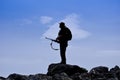 Silhouette of a hunter in front of blue sky