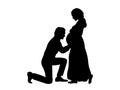 Silhouette husband kneels in front of his pregnant wife side view