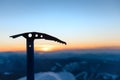 Silhouette of iceaxe against sunset