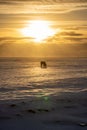 Silhouette of an Icelandic horse with the snowy ground at sunset, under a cloudy and orange sky due to the first rays of the sun Royalty Free Stock Photo