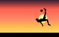 Silhouette illustration of a soccer player doing an overhead kick with a sunset in the background Royalty Free Stock Photo
