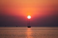 Silhouette image of a sunset at the sea with sailing boat